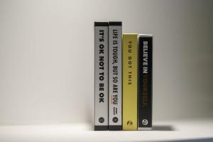 three books standing next to each other on a shelf at 5 Stockland Street in Caerphilly +49 photos