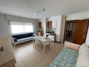 a living room with a couch and a table at Apartamentos Telleira in Nigrán