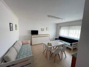 a living room with a couch and a table at Apartamentos Telleira in Nigrán