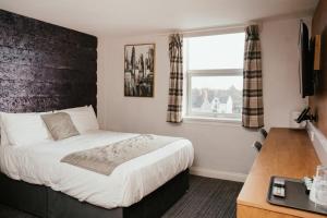 a bedroom with a bed and a window at Hotels 24-7 - The Old Victoria Hotel in Newport