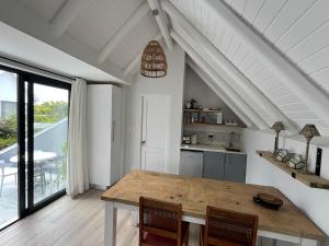 a kitchen with a wooden table and chairs in a room at 35 On the Run in St Francis Bay