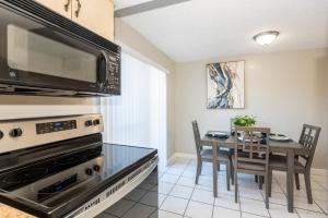 a kitchen with a table with chairs and a microwave at New Fall Rates-8 Mins from Beach-Speedway and Golfing in South Daytona