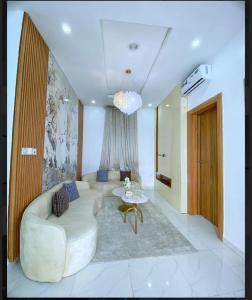 a living room with a couch and a table at Luxury 4 bedroom duplex in Lagos