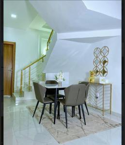 a dining room with a table and chairs at Luxury 4 bedroom duplex in Lagos