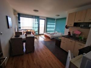 a room with a kitchen and a living room at Azur Apartments in Sozopol +55 photos