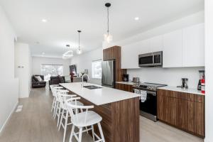 a kitchen with wooden cabinets and white counter tops at 3Bedrooms Apartment Near YWG Airport in Winnipeg