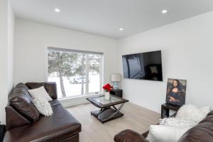 a living room with a couch and a tv at 3Bedrooms Apartment Near YWG Airport in Winnipeg