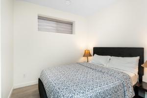 a bedroom with a bed and a window at 3Bedrooms Apartment Near YWG Airport in Winnipeg