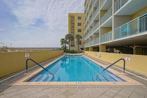 a swimming pool in front of a building at Pelican Isle 206 in Fort Walton Beach