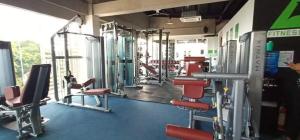 a gym with lots of chairs and machines at B&M Rental- Antara in San Isidro