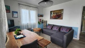 a living room with a couch and a table at Beach Front Apartment Eljocri in Capbreton