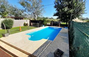 a swimming pool in a backyard with a fence at Los trevi in Rosario