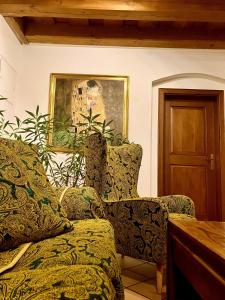 a living room with two chairs and a painting at Prague Romantic Apartment near Charles Bridge in Prague