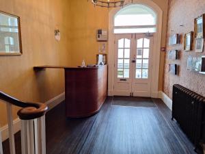 a bar in a room with a hallway with a door at Swn Y Mor in Llandudno +7 photos