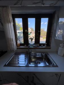 a kitchen sink with a window above it at Little Paradise in Sotira +77 photos