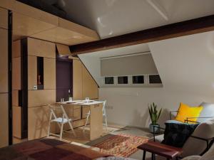 a living room with a table and a couch at Browhill Loft - contemporary, handcrafted studio in Danehill