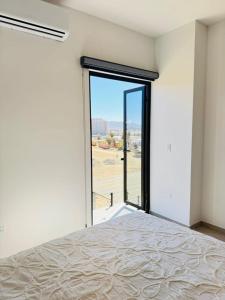 a bedroom with a bed and a large glass door at Los Cerritos Oceanview at The Point,8 in San Carlos +29 photos