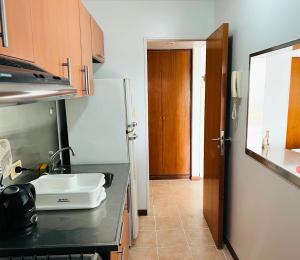 a kitchen with a sink and a counter top at Excelente departamento, a metros del Shopping Paso del Paraná, vista al río Paraná - silencio - ideal para descansar - barrio residencial - Cámaras de seguridad 24hs - unidad Monitoreada in Paraná +10 photos