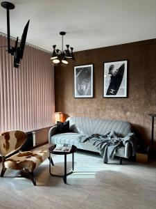 a living room with a bed and a couch at Business Park Sofia Cozy Lux & Private Garage Option in Sofia