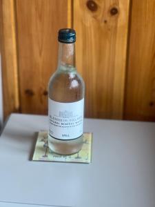 a bottle of alcohol sitting on top of a table at Little Pink Cabin in Church End