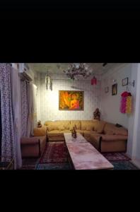 a living room with a couch and a table at Ravi niwas in Prayagraj
