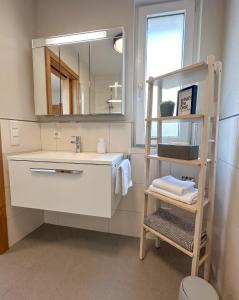 ゼーキルヒェン・アム・ヴァラーゼーにある"ONE" - Premium Apartments Seekirchen - Dein Rückzugsort mit exklusivem Flair und privater Terrasseの洗面台と鏡のあるバスルーム