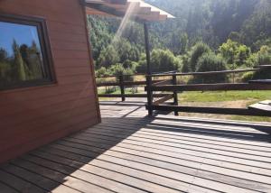 a wooden deck with a bench on a house at Casona octava región in Concepción
