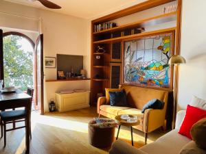 a living room with a couch and a stained glass window at Lake Front View on Viale GENO in Como