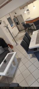 a living room with a table and chairs and a laptop at Apartman Marinero in Kutjevo +17 photos