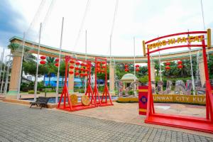 a amusement park with a carousel in front of a building at GM Grand Moments Bandar Sunway in Petaling Jaya