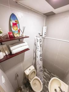 a bathroom with a toilet and a sink at The Loft 2 in Cabanatuan
