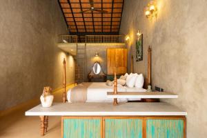a bedroom with a bed and a table in it at Jungle Park Resort-Rain Forest Experience by GreenEscapes in Vythiri