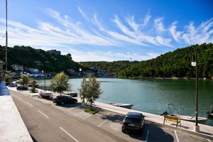 a street with cars parked next to a river at Apartment Bazdaric in Novigrad Dalmatia