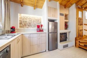 a kitchen with a stainless steel refrigerator and a stove at Nymfes Corfu Apartments in Corfu Town