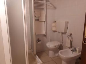 a white bathroom with a toilet and a sink at Borgo incantato in Villar Dora