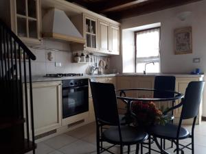 a kitchen with a table and chairs and a stove at Borgo incantato in Villar Dora
