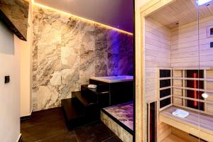 a bathroom with a shower with a stone wall at Amari120Suite&Spa in Palermo +46 photos