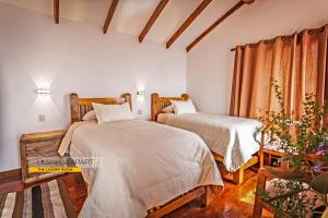 a bedroom with two beds and a window at Utasawa Loft APART in Comunidad Yumani