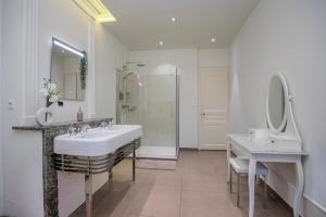 a white bathroom with a sink and a mirror at Bedroom 2 - Authentic charm - COLIVING Historic House in Ferney-Voltaire +29 photos