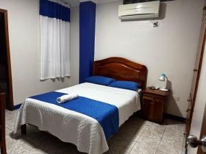 Postel nebo postele na pokoji v ubytování Hostal León Dormido