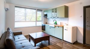 a small kitchen with a couch and a refrigerator at Guest apartment LOM in Ruse