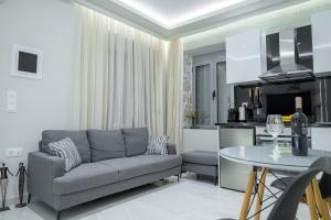 a living room with a couch and a table at George luxury stone apartment in Vonitsa