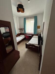 a room with a bedroom with a bed and a mirror at Parkhotel Rottweil in Rottweil
