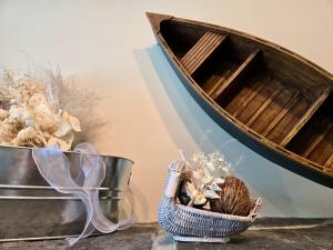 a wooden boat on a table with a basket of flowers at Pika's Place Bed and Breakfast in Canmore