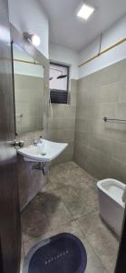 a bathroom with a sink and a toilet at Sky Apartment Viyathpura Colombo in Sri Jayewardenepura Kotte +18 photos