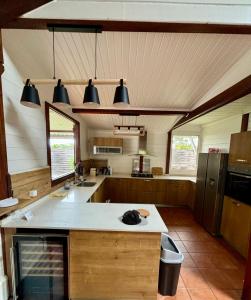 a large kitchen with a island in the middle at villa créole avec piscine privée in Petit-Bourg