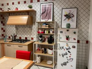 a kitchen with a refrigerator with magnets on it at B&B Resort Palazzo Pirozzi in Boscoreale