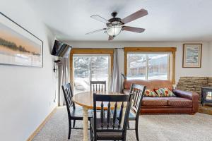 a living room with a table and chairs and a couch at The Ponderosa at Aspen Village in McCall