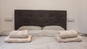 a bedroom with a large bed with towels on it at Apartman Sandra -private parking and garden in Zadar