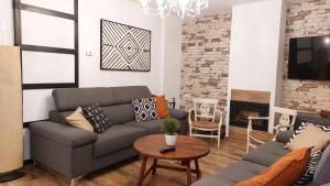 a living room with a couch and a table at Casa Rural La Garnacha in Alpera